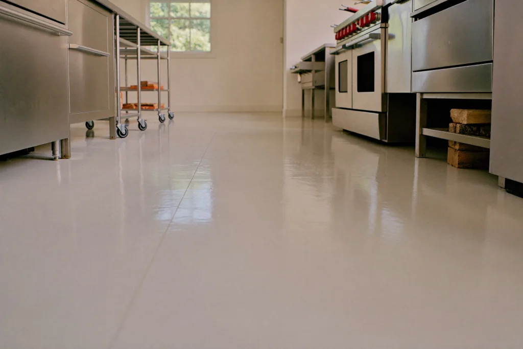 Heat-resistant resin floor around a fryer line in an empty commercial kitchen