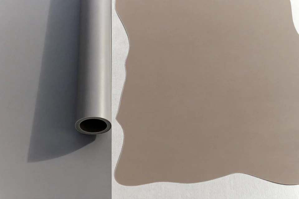 Roll of vinyl flooring beside a poured resin sample