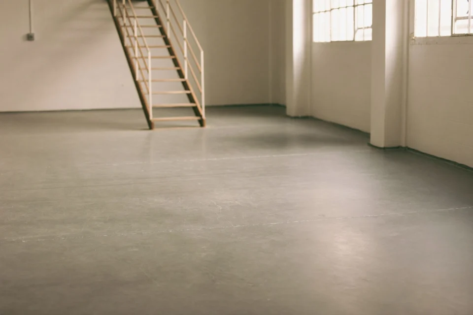 Freshly sealed grey epoxy floor on an empty factory mezzanine