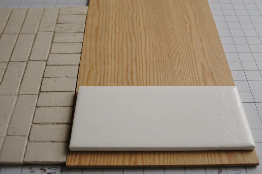 Quarry tile, vinyl plank and poured resin sample on a plan table