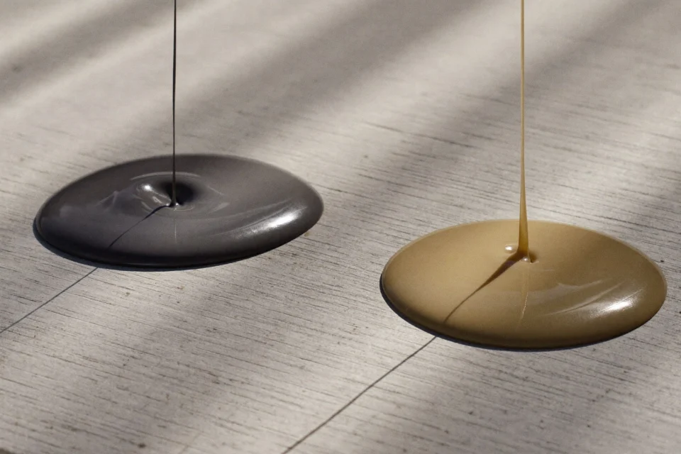 Two resin floor samples side by side, glossy grey epoxy and satin polyurethane