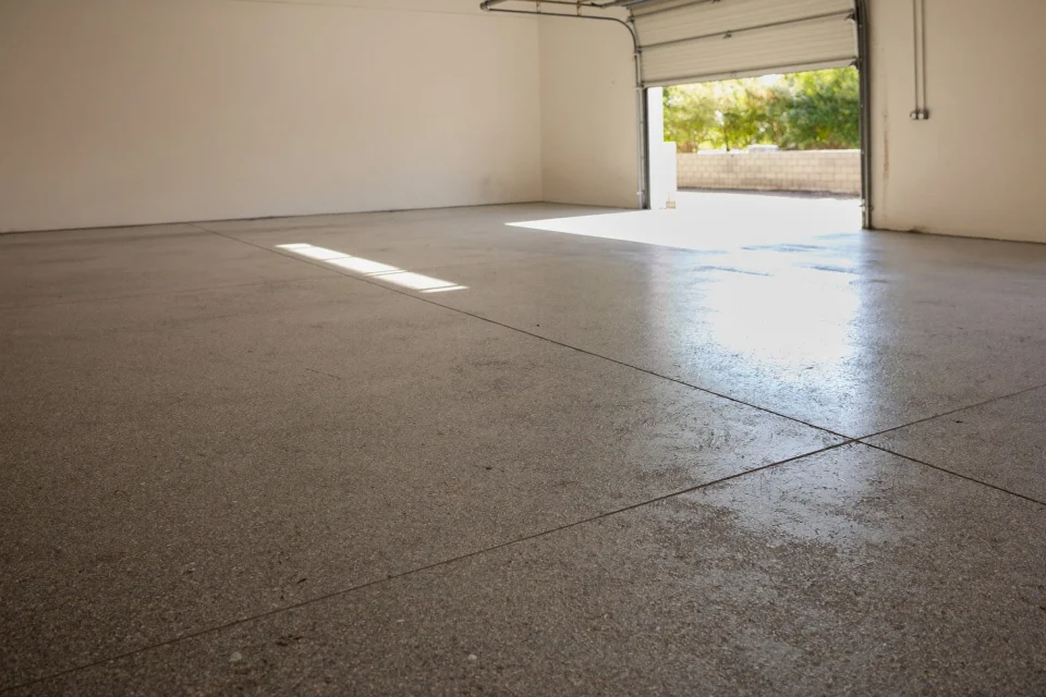 Flake-broadcast resin floor in an empty double garage